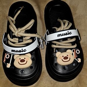 Kids Black Sandal Clogs with Beige Bear Charm and White 'Music' Strap
